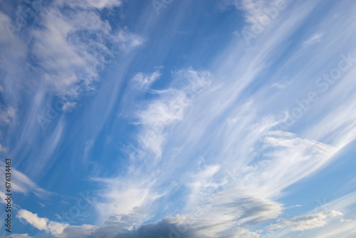 Fototapeta Naklejka Na Ścianę i Meble -  A dramatic sky with majestic cirrus clouds stretched across a blue dome. Their thin and graceful forms create a spectacular spectacle, reminiscent of the majesty of nature