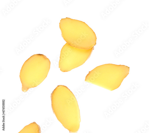 Flying slices of fresh ginger root on white background