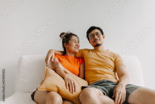 Lovely romantic asian couple watching tv movie together happy vibes weekends.