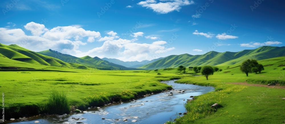 In the summer as I travel through the stunning landscape the beauty of the background captivates me with its lush green grass towering mountains and vibrant blue sky reflected in the tranqu In the summer as I travel through the stunning landscape the beauty of the background captivates me with its lush green grass towering mountains and vibrant blue sky reflected in the tranqu