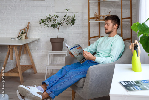 Young bearded man reading m...