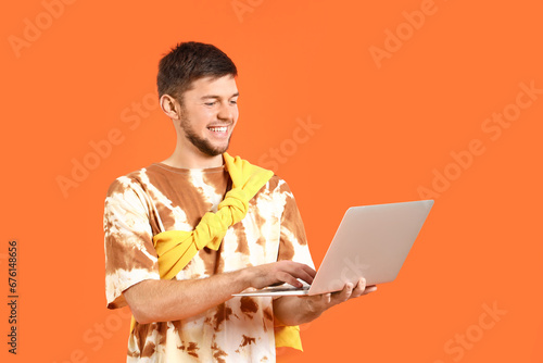 Young bearded man using lap...