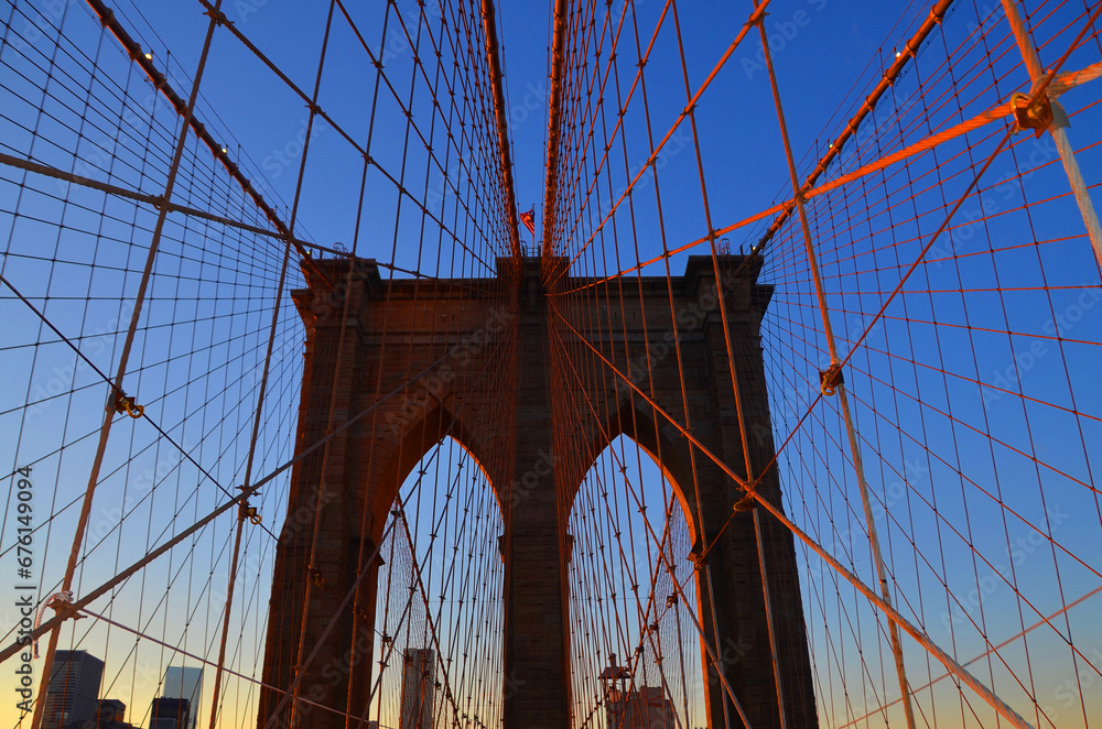 Fototapeta premium Brooklyn Bridge is one of the oldest suspension bridges in the US. Completed in 1883, it connects the New York City boroughs of Manhattan and Brooklyn by spanning the East