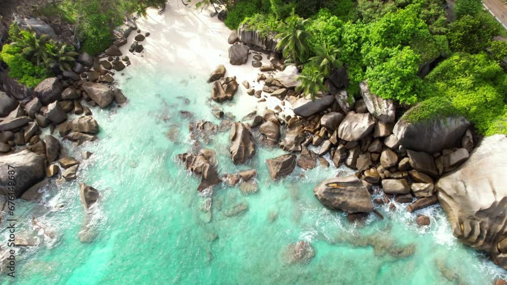 Bird eye drone shot of hidden beach near north east point beach, huge rock boulders, white sandy beach and turquoise water, Mahe Seychelles 30fps Bird eye drone shot of hidden beach near north east point beach, huge rock boulders, white sandy beach and turquoise water, Mahe Seychelles 30fps