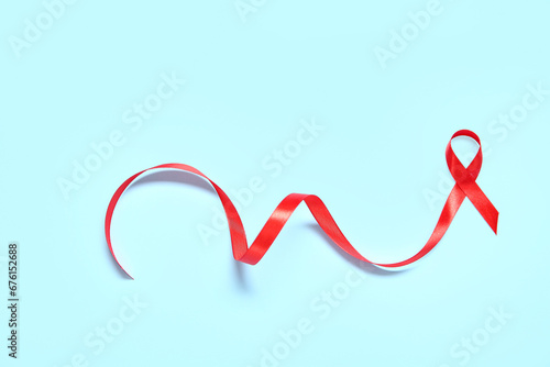 Red ribbon on blue background. AIDS Day concept