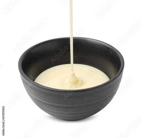 Pouring condensed milk into bowl isolated on white