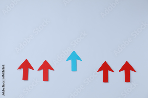 Red and light blue paper arrows on white background, flat lay. Space for text