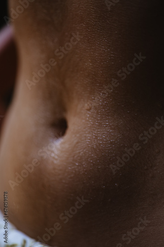 Bodyscape of a nude woman with wet stomach