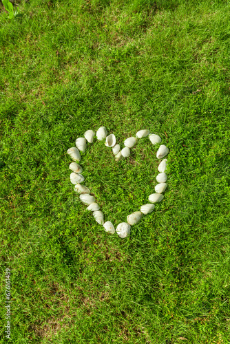 Stone Heart form on green grass 
