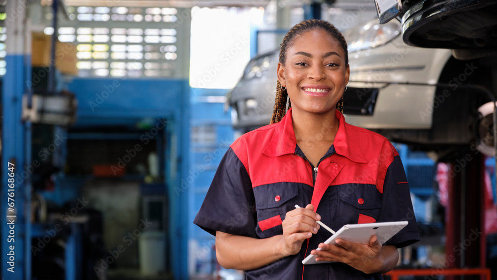 Happy Black female supervisor mechanic, cheerful smile, inspects repair work checklists with tablet at garage, service car maintenance, and fixing specialist occupations in auto transport industry. - obrazy, fototapety, plakaty 