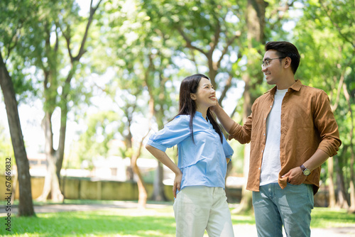 Photo of young Asian couple at park photo