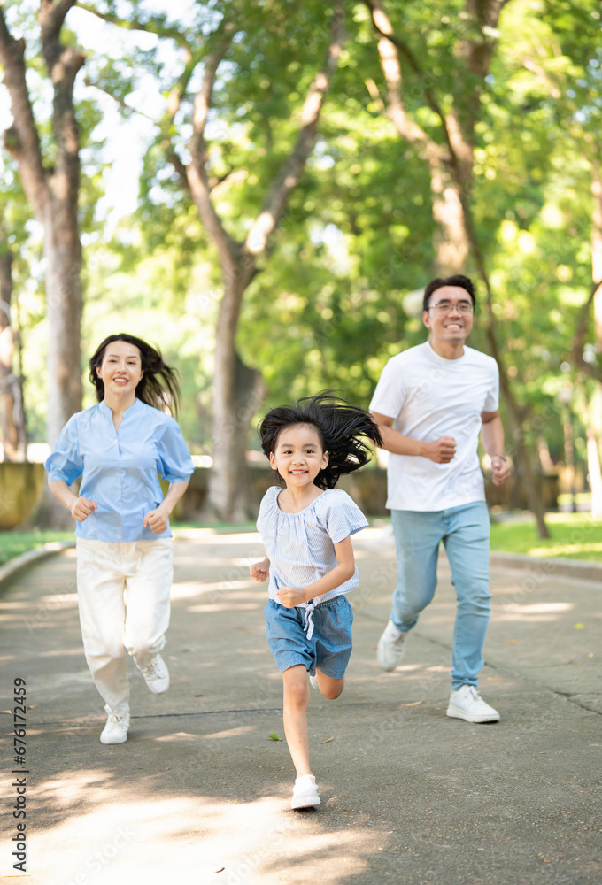 Photo of young Asian family at park