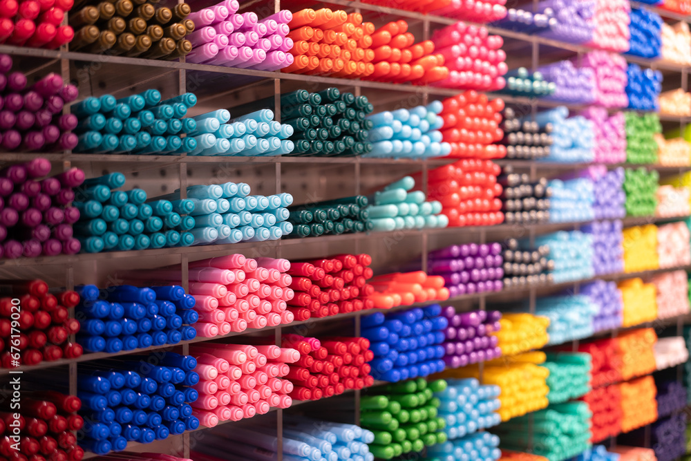 Background of lots assorted colorful pen set. Colored pens on shelves In the shop,Office supplies and stationery. Colorful pens arranged on shelves selling stationery.