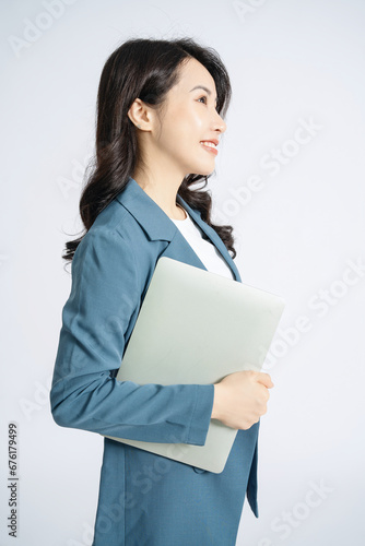 Image of young Asian business woman on background