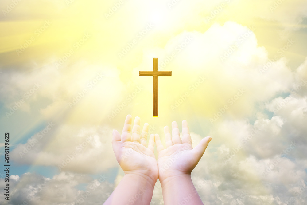 Conceptual image of a Christian cross in the hands of a child