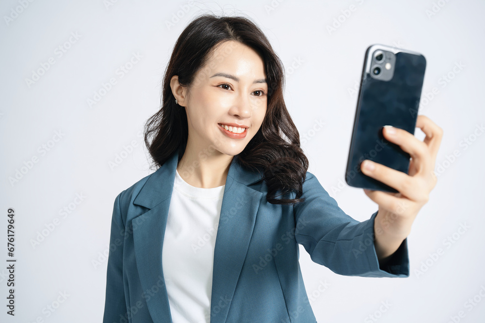 Image of young Asian business woman on background Image of young Asian business woman on background