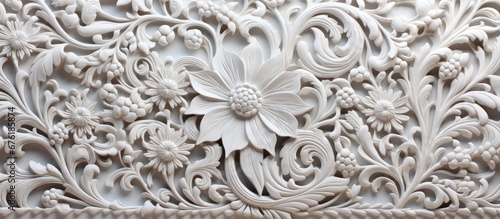 The intricate Indian ornament inspired by the old stone structures of India adds a touch of elegance and cultural richness to the white marble background creating a mesmerizing pattern resem