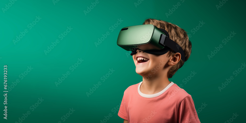 Young boy getting experience using VR headset glasses isolated on a green background with copy space Young boy getting experience using VR headset glasses isolated on a green background with copy space