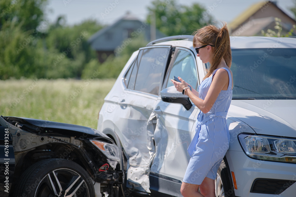 Sad female driver speaking on sellphone on street side calling for emergency service after car accident. Road safety and insurance concept Sad female driver speaking on sellphone on street side calling for emergency service after car accident. Road safety and insurance concept