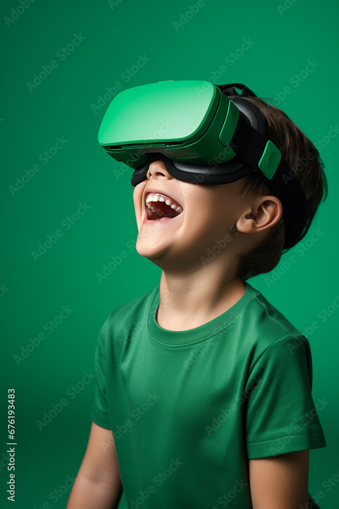 Young boy getting experience using VR headset glasses isolated on a green background Young boy getting experience using VR headset glasses isolated on a green background