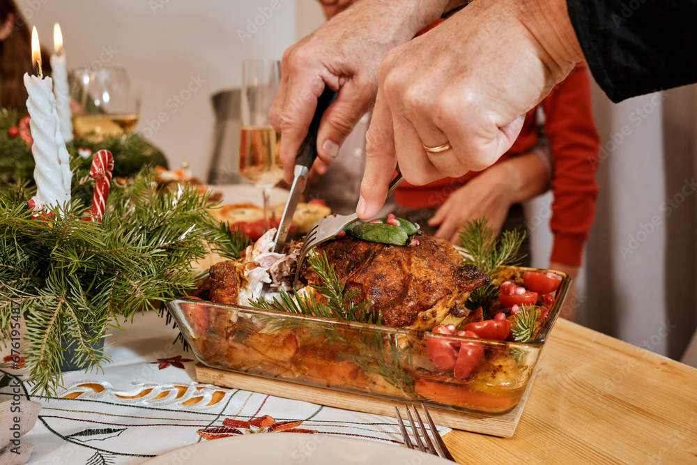 Christmas family dinner, Christmas decor, holiday table top view, celebrating the new year together, spread a hot dish, turkey leg, chicken in plates, close-up of hands cutting roast turkey