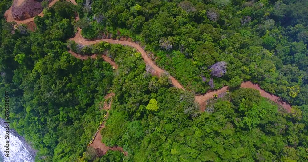 Aerial video looking down on a walking path cutting through the mountains of Playa Herradura in Costa Rica Aerial video looking down on a walking path cutting through the mountains of Playa Herradura in Costa Rica