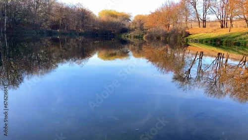 Warm autumn days yellow leaves reflection mirror pond. High quality FullHD footage
