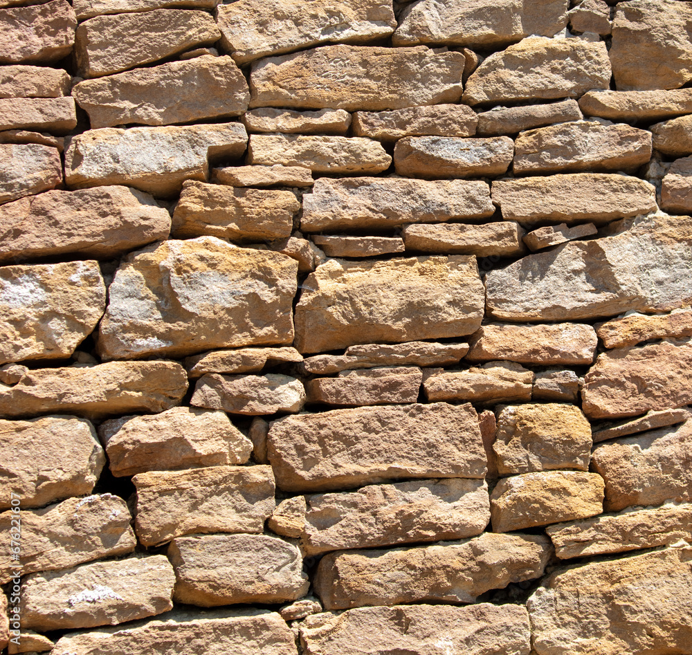 Fototapeta premium Ancient stone bricks in the wall as a background. Texture