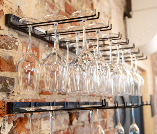 Glass glasses on a bar near a brick wall
