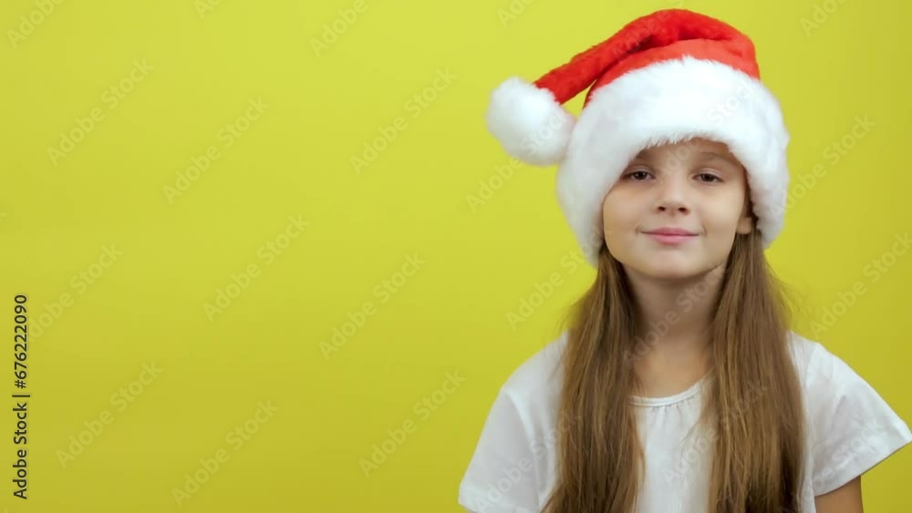 New year baby portrait, little girl smiling isolated on yellow background showing emotions New year baby portrait, little girl smiling isolated on yellow background showing emotions