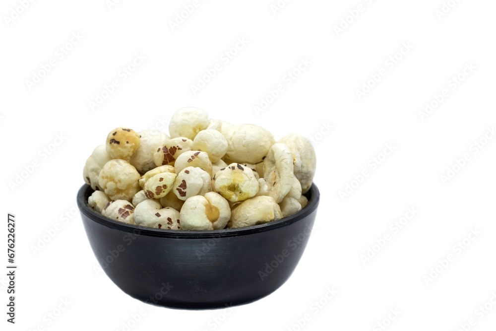 Makhana or Fox Nut in a Black Bowl Isolated on White Background with Copy Space, Also Known as Lotus Seed Pop, Euryale Ferox or Gorgon Nut Makhana or Fox Nut in a Black Bowl Isolated on White Background with Copy Space, Also Known as Lotus Seed Pop, Euryale Ferox or Gorgon Nut