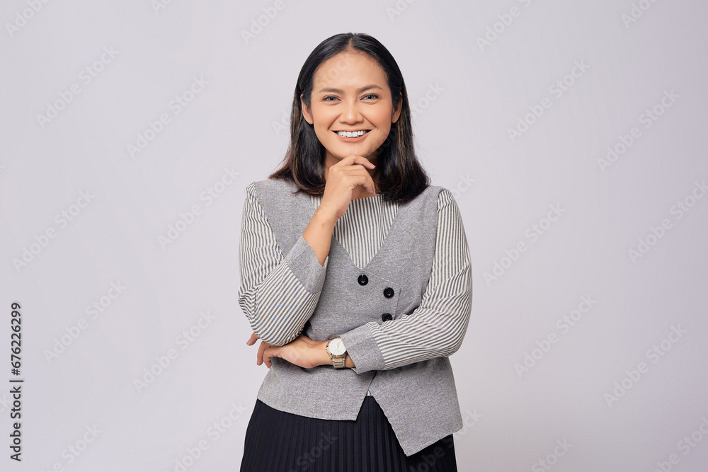 Smiling beautiful young Asian woman in casual clothes hand on chin, looking at the camera, thinking about opportunities isolated on white background. People lifestyle emotion concept Smiling beautiful young Asian woman in casual clothes hand on chin, looking at the camera, thinking about opportunities isolated on white background. People lifestyle emotion concept