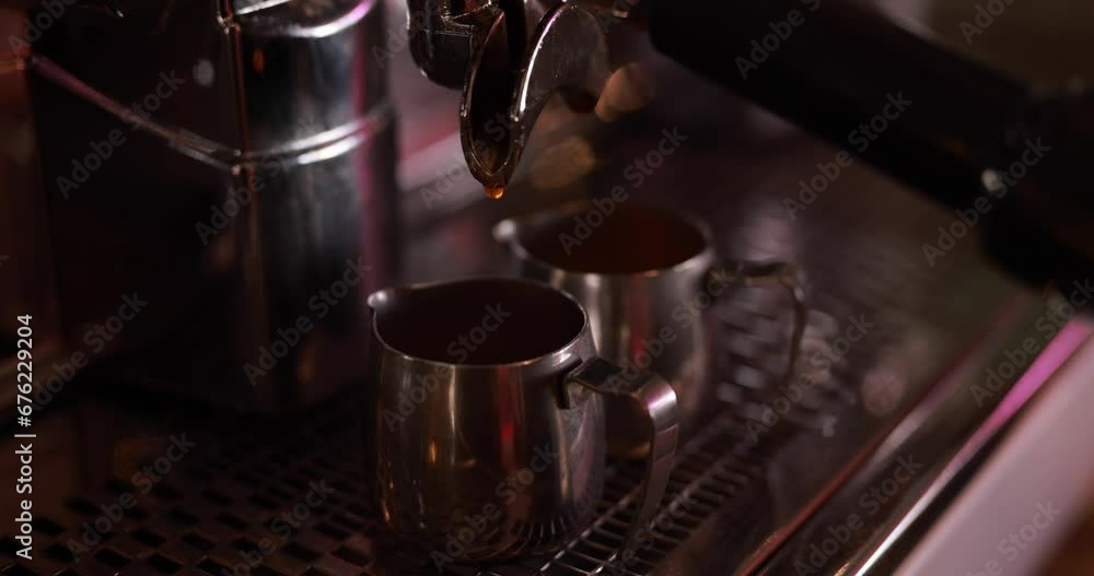 Coffee machine making espresso, coffee pouring into little cups Coffee machine making espresso, coffee pouring into little cups