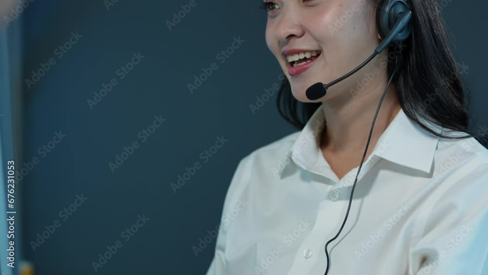 Asian businesswoman, successful call center, sitting at a table wearing headphones and talking Consulting with customers online with PC computer, online business concept. Asian businesswoman, successful call center, sitting at a table wearing headphones and talking Consulting with customers online with PC computer, online business concept.
