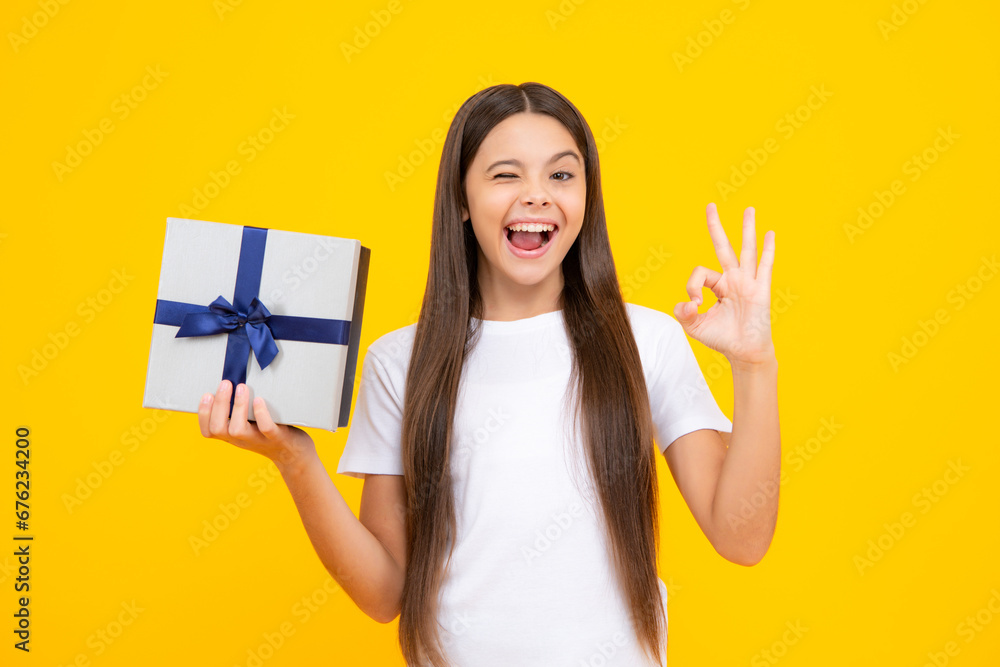 Happy teenager portrait. Child teen girl 12-14 years old with gift on isolated background. Birthday, holiday concept. Teenager hold present box. Smiling girl. Happy teenager portrait. Child teen girl 12-14 years old with gift on isolated background. Birthday, holiday concept. Teenager hold present box. Smiling girl.