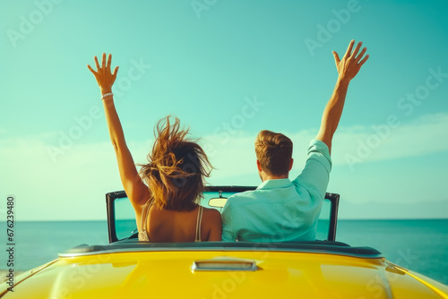 Young couple enjoying a seaside drive in a convertible photo