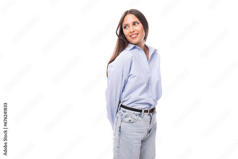 young smiling caucasian model woman with dark straight hair dressed in a blue blouse on a white background with copy space young smiling caucasian model woman with dark straight hair dressed in a blue blouse on a white background with copy space