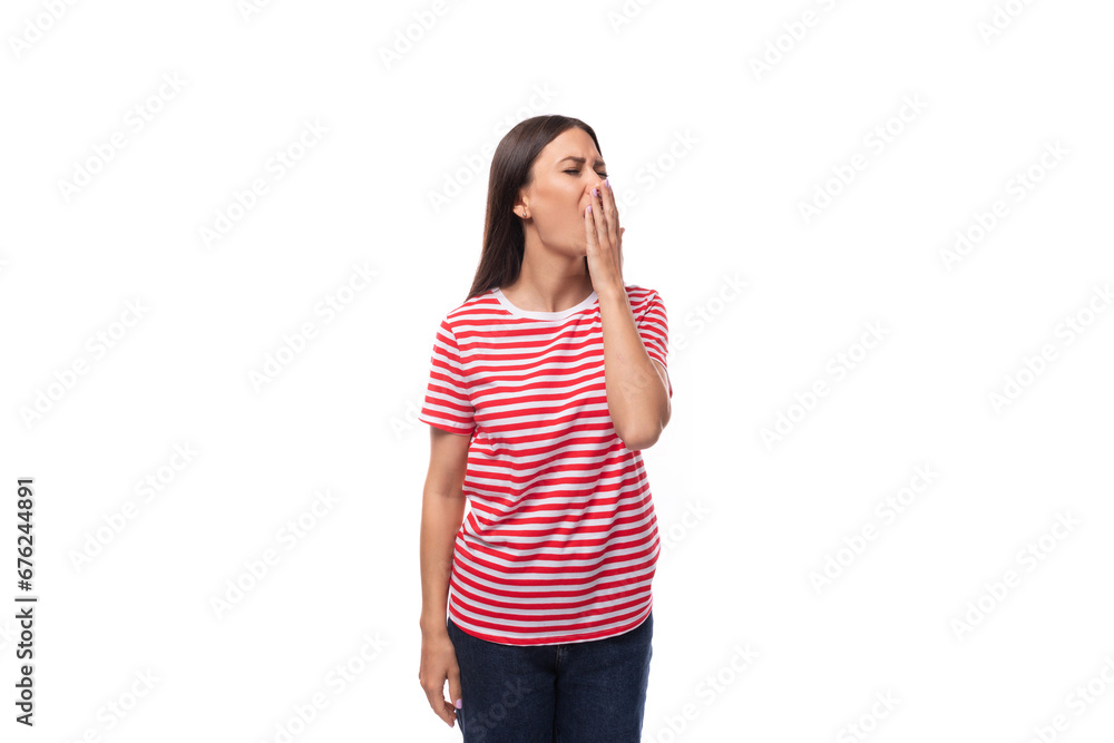 charming pretty 35 year old european lady in a red striped t-shirt yawns from fatigue on a white background with copy space charming pretty 35 year old european lady in a red striped t-shirt yawns from fatigue on a white background with copy space