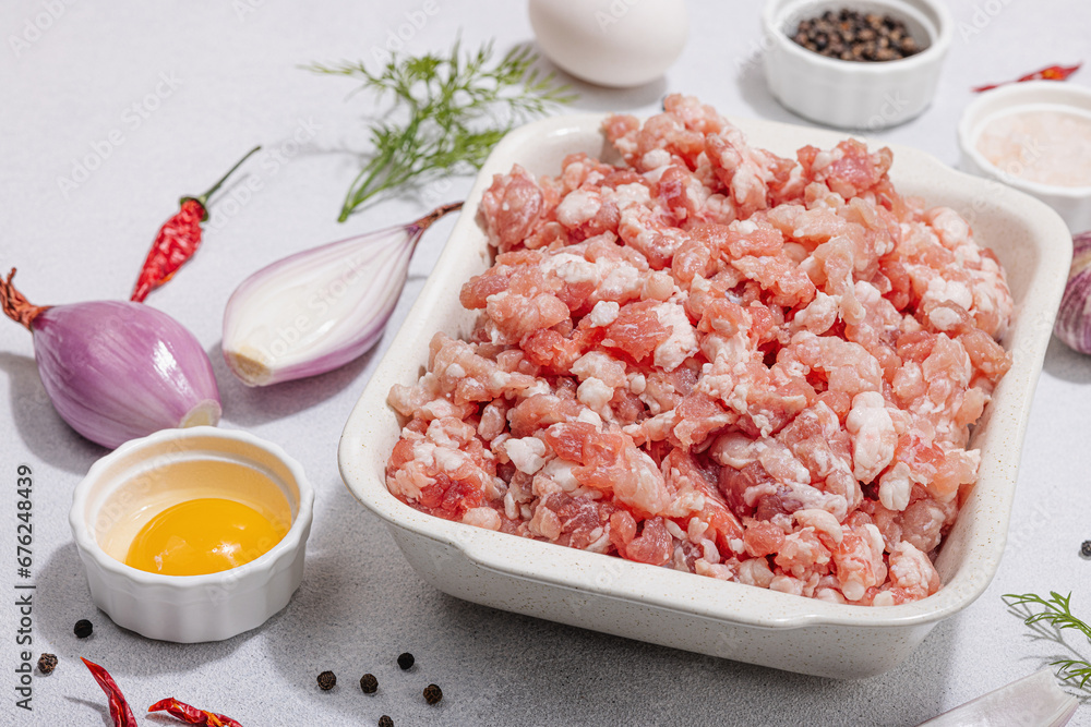 Raw minced meat, spices and herbs. Traditional ingredients for cooking cutlets or meatballs Raw minced meat, spices and herbs. Traditional ingredients for cooking cutlets or meatballs