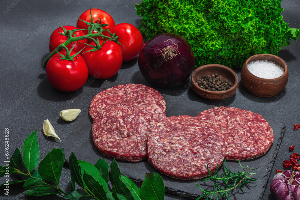 Raw burger patties. Fresh meat cutlets, spices, vegetables, herbs. Homemade American classic Raw burger patties. Fresh meat cutlets, spices, vegetables, herbs. Homemade American classic