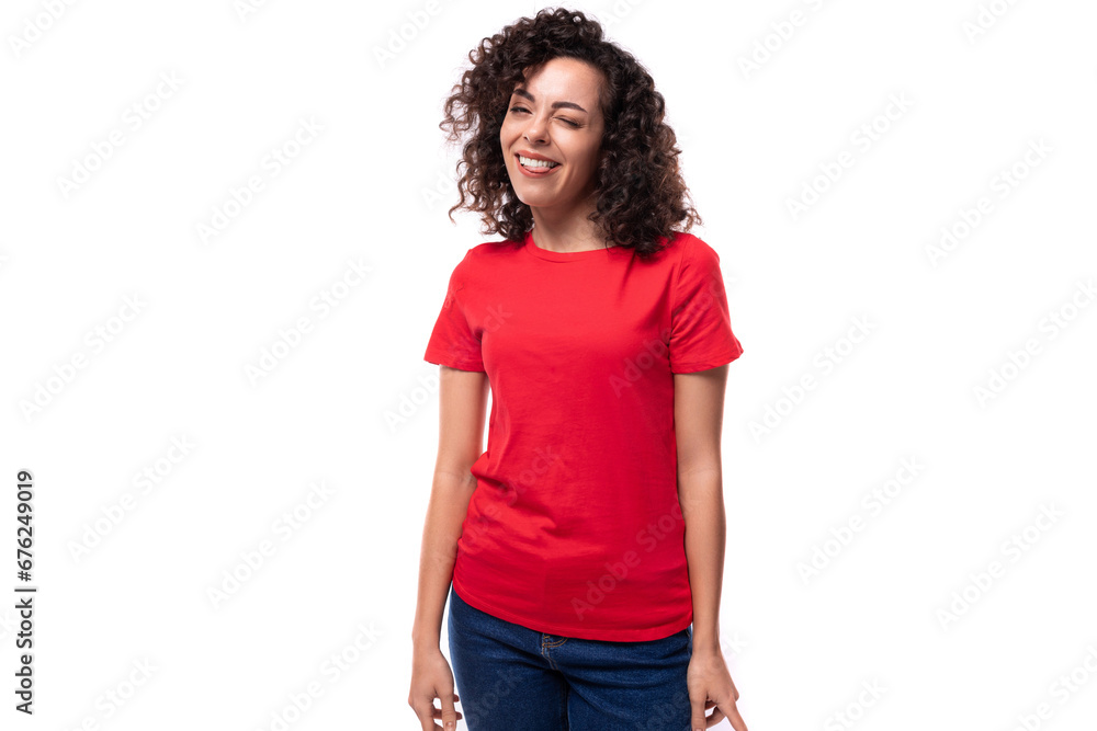 corporate clothing concept. young smiling curly brunette woman in red t-shirt on white background with copy space corporate clothing concept. young smiling curly brunette woman in red t-shirt on white background with copy space