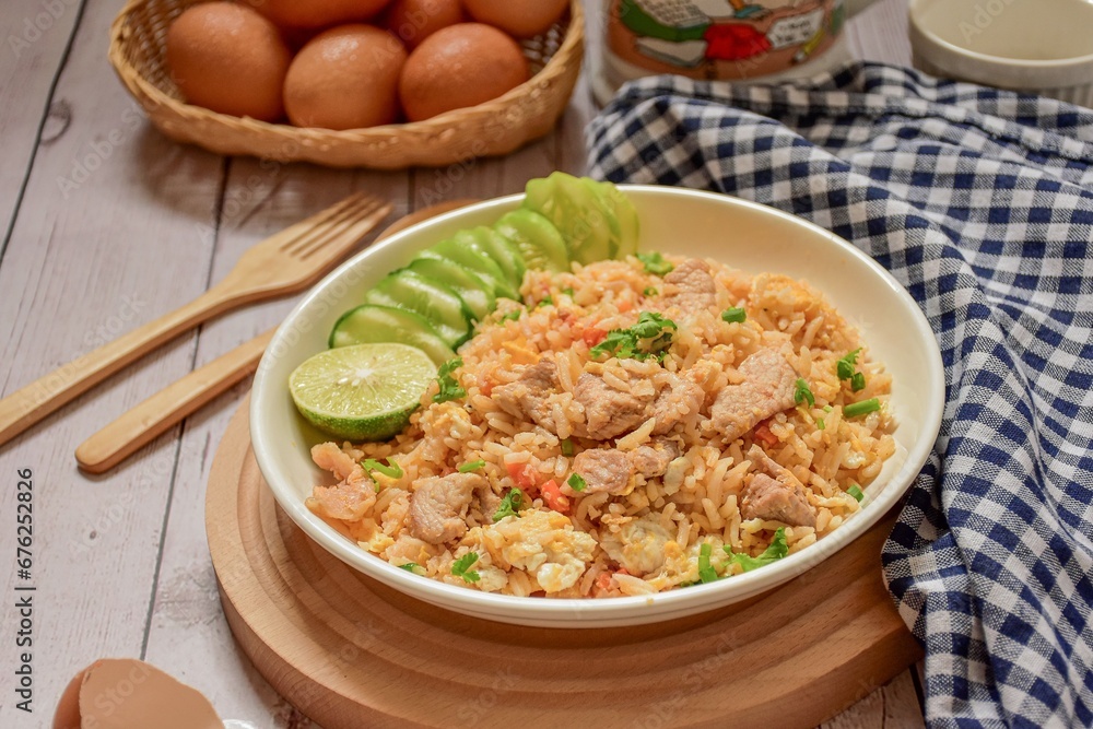 Fried rice with pork and egg on the white plate Fried rice with pork and egg on the white plate