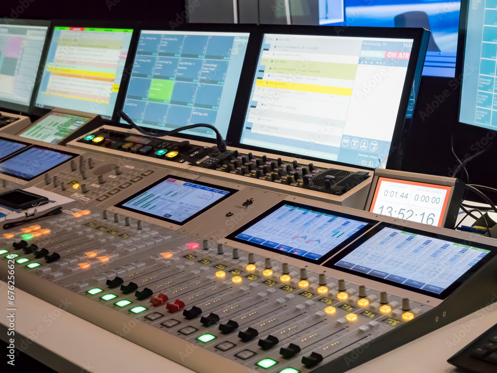 Technical room with audio mixing console and studio equipment in recording, broadcasting, editing studio Technical room with audio mixing console and studio equipment in recording, broadcasting, editing studio