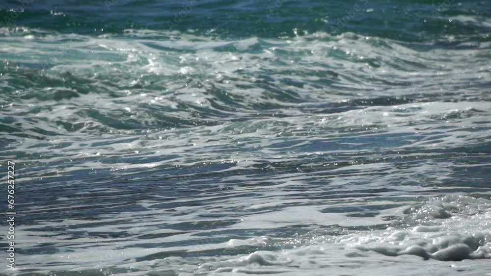 Sea water surface. Low angle view over clear azure sea water. Sun glare. Abstract nautical summer ocean nature. Holiday, vacation and travel concept. Nobody. Slow motion. Weather and climate change Sea water surface. Low angle view over clear azure sea water. Sun glare. Abstract nautical summer ocean nature. Holiday, vacation and travel concept. Nobody. Slow motion. Weather and climate change