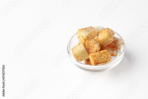 Homemade crispy croutons. Cubes of crusty bread, white fried crackers in the form of a slide. Copy space. Isolated object.