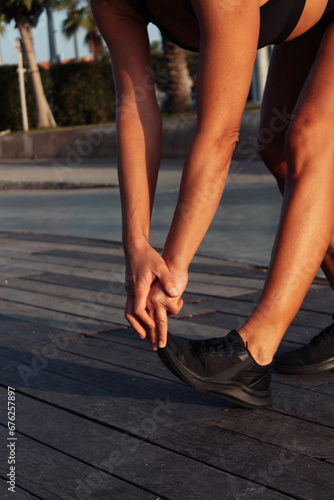 a woman stretches, reaches her toes