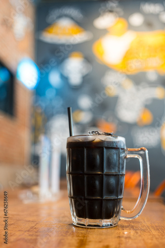 Thai iced black coffee signature local beverage on wooden background called oliang photo