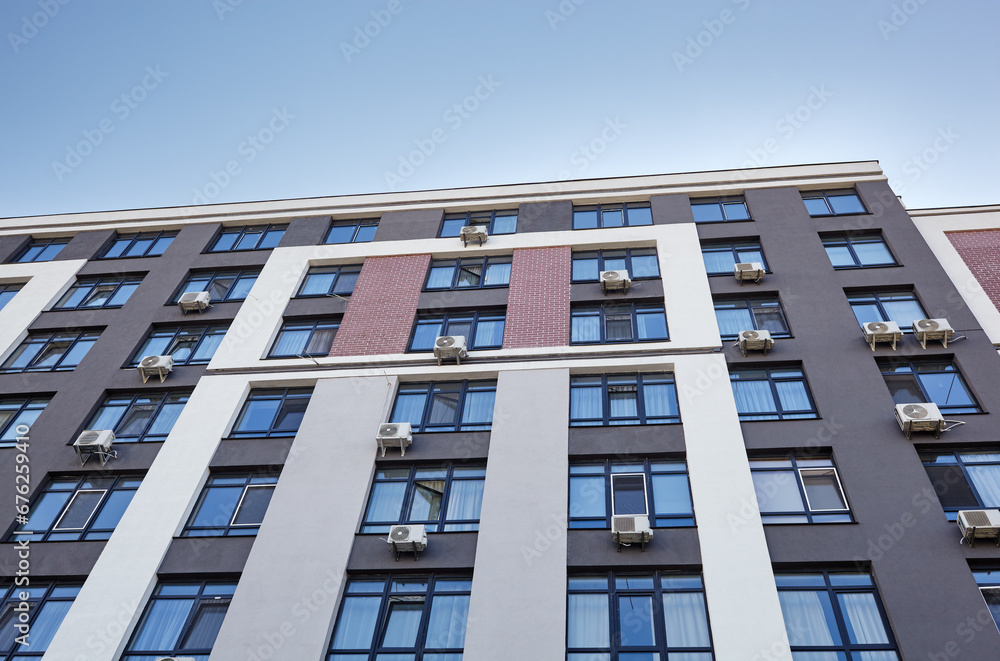 Modern apartment buildings on a sunny day with a blue sky. Facade of a modern European apartment building