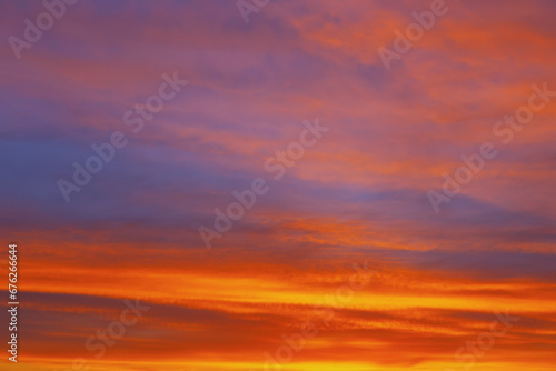 Tranquil canvas of the evening sky with  red wavy clouds © russieseo