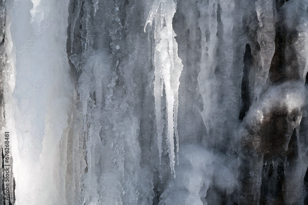 frozen icicles and icing on a stone wall in winter close-up frozen icicles and icing on a stone wall in winter close-up